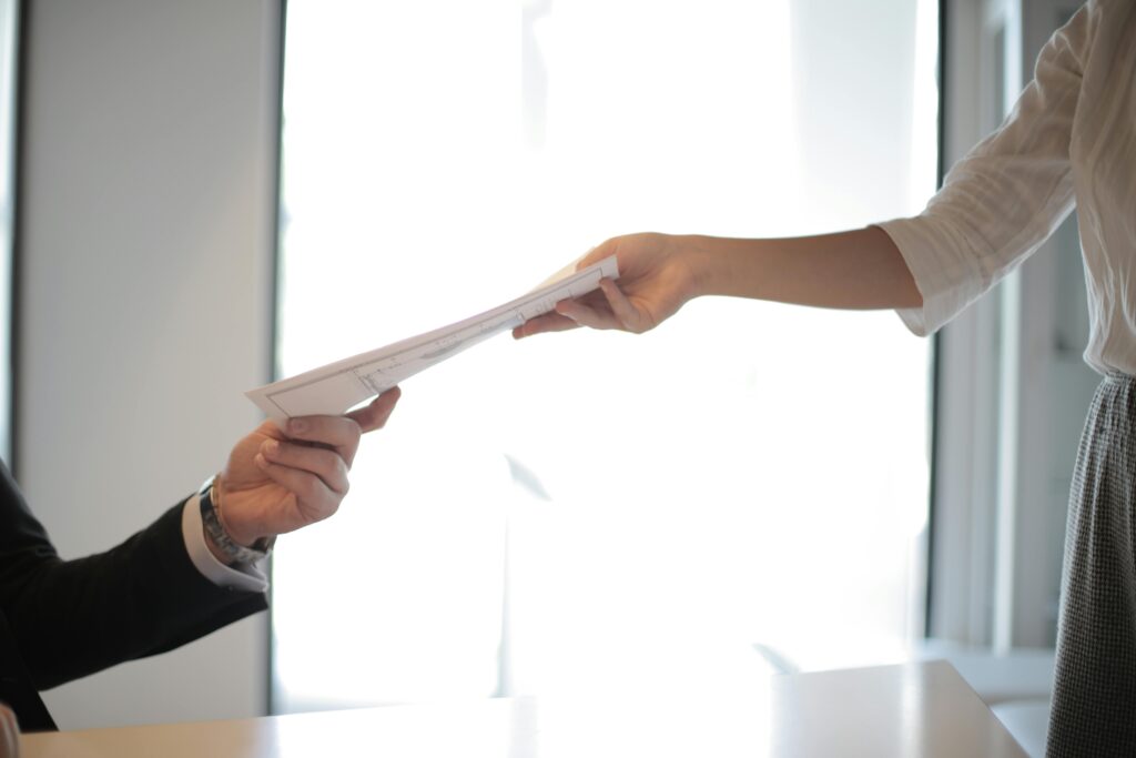 One person handing over a quotation to another